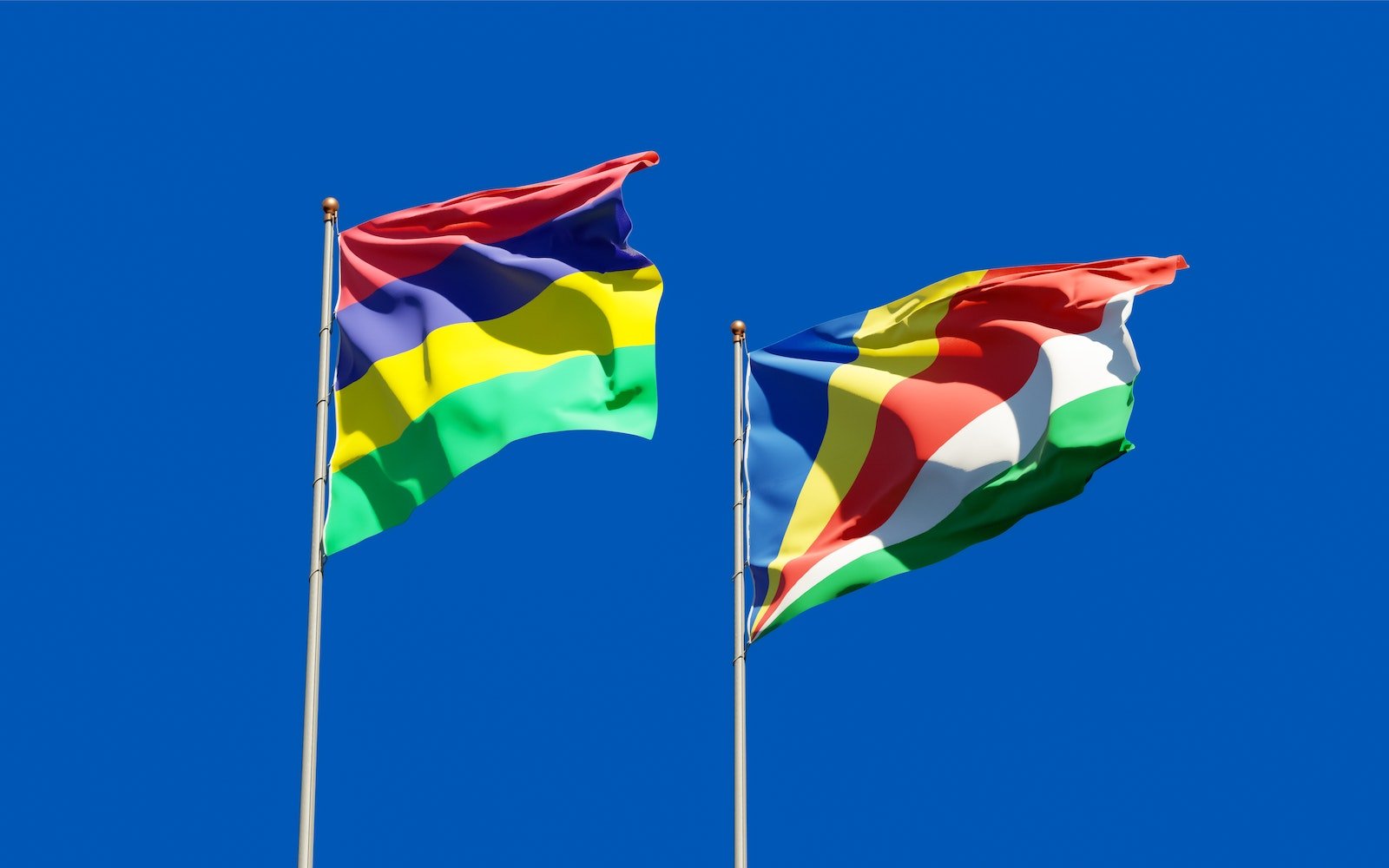 Seychelles and Mauritius Flags Under the Blue Sky
