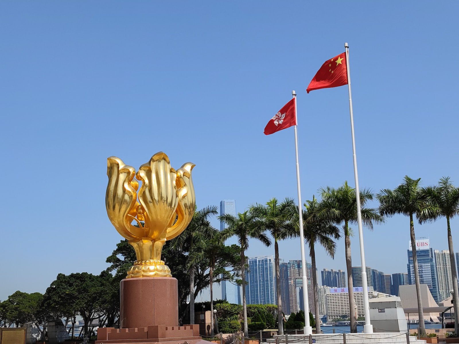 a golden trophy with flags in the background