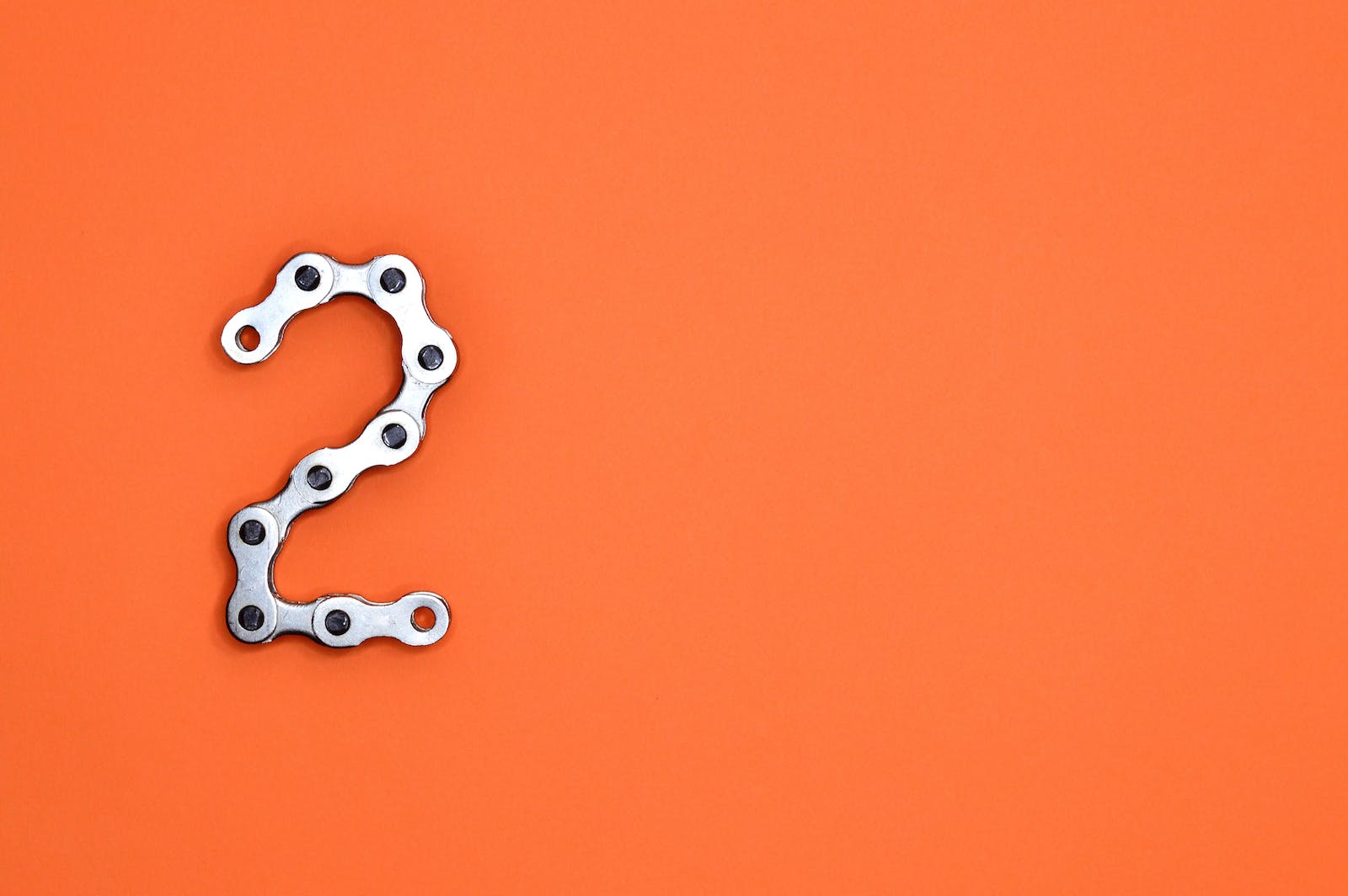 Gray Steel Chain on Orange Surface