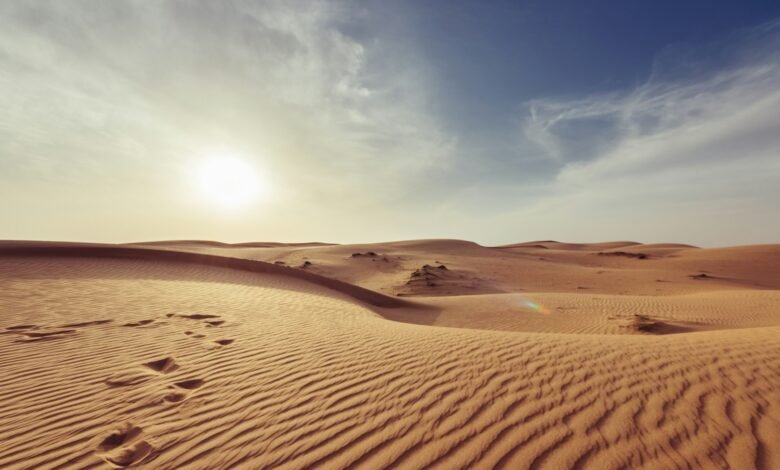 gray sand under white and blue sky