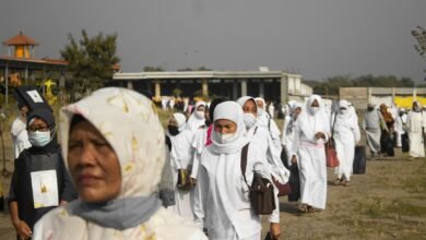 people in white hijab standing on brown field during daytime