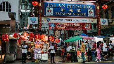 A street with people walking and a sign that says tian petaling street