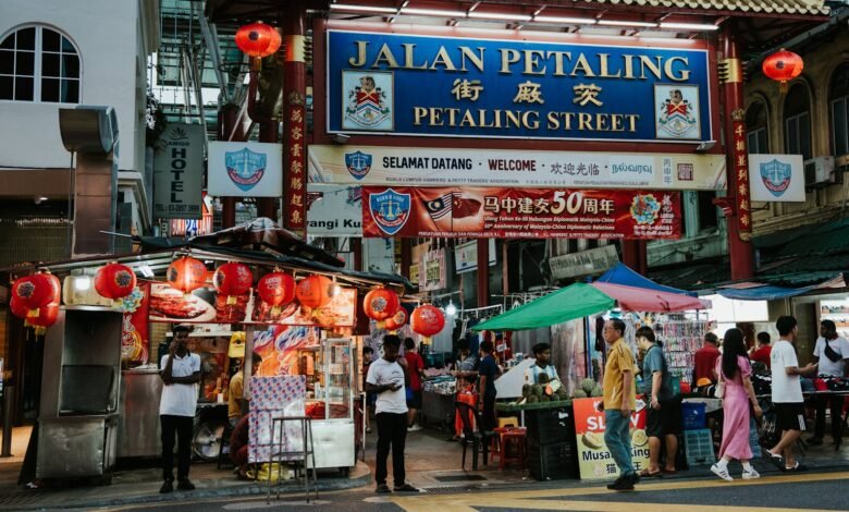 A street with people walking and a sign that says tian petaling street