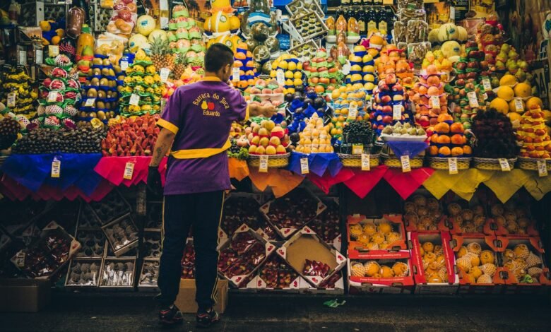 man standing in front of produce stand