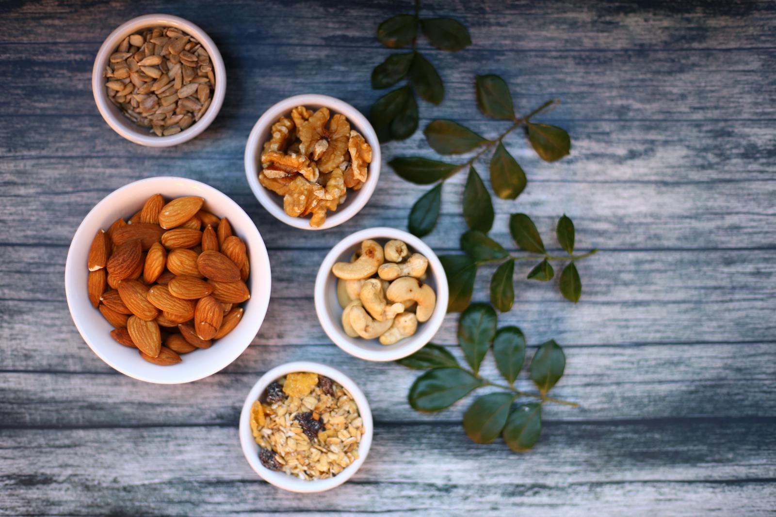 Assorted Nuts in White Ceramic Bowls