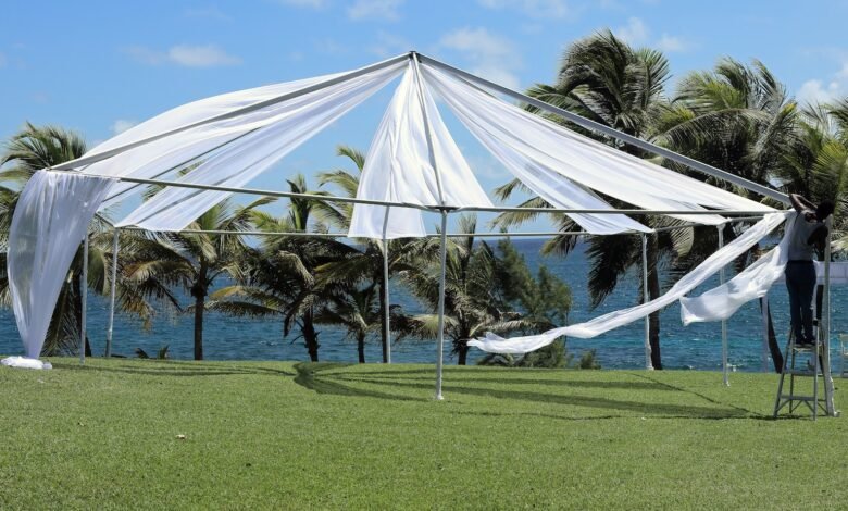 white canopy tent on green grass field during daytime