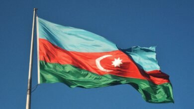 red and white flag under blue sky during daytime