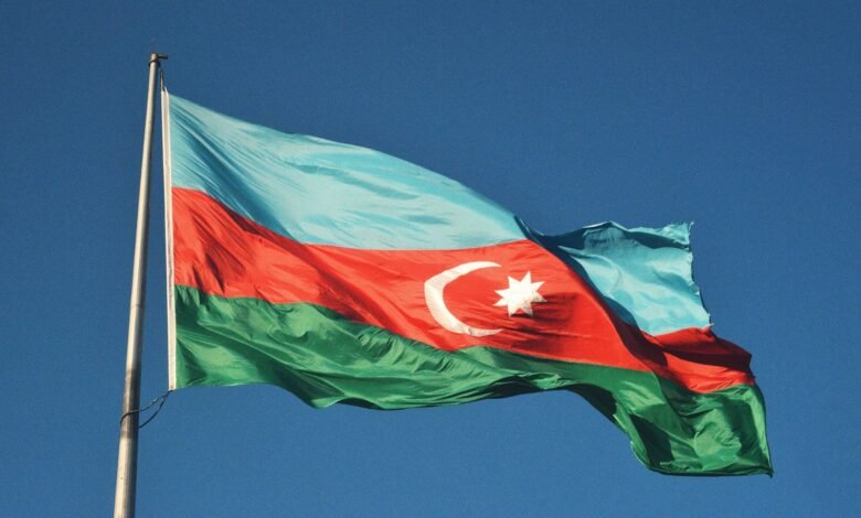 red and white flag under blue sky during daytime