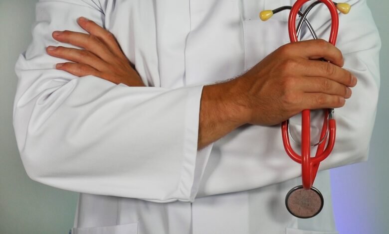 doctor holding red stethoscope