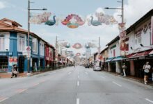 a street lined with shops and people walking down it