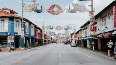 a street lined with shops and people walking down it