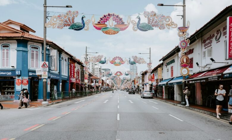 a street lined with shops and people walking down it