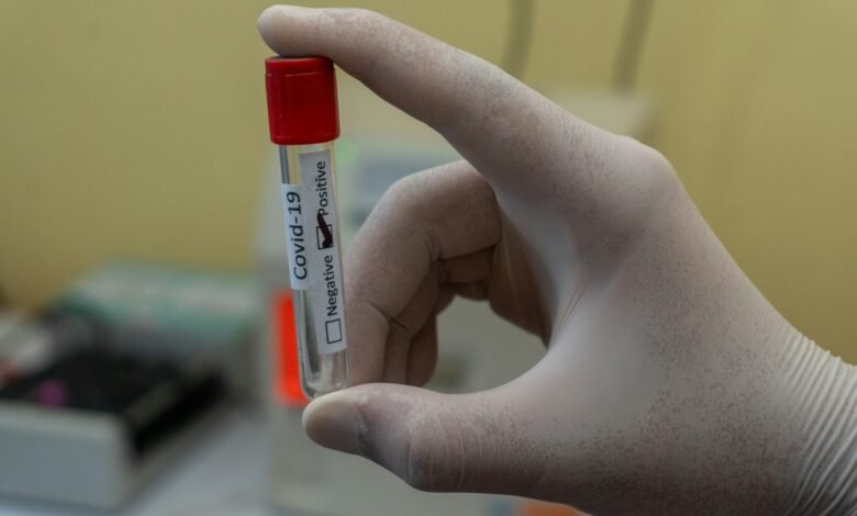 person holding white and red plastic tube