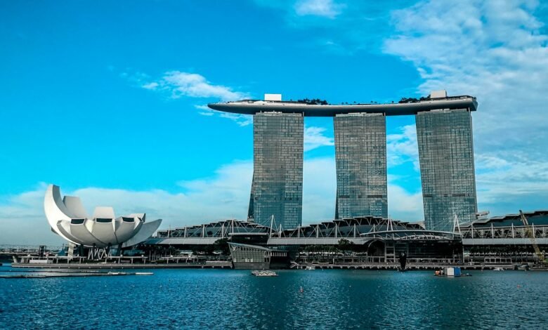 gray concrete buildings near body of water