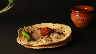 A pita bread with a green pepper on top of it