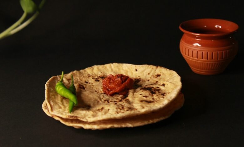 A pita bread with a green pepper on top of it