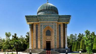 Mausoleum of Imam al-Matrudiy in Samarkand, showcasing architectural brilliance under a clear blue sky.