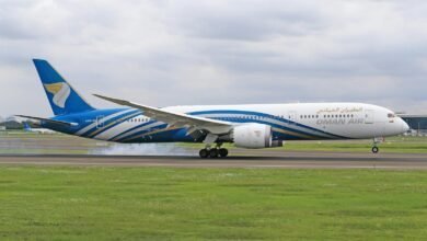 Oman Air Boeing 787 Dreamliner prepares for takeoff on a cloudy day.