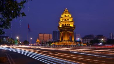 Long exposure night photograph of the illuminated Independence Monument with light streaks in Phnom Penh, Cambodia.