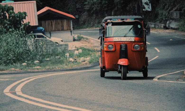 red car on gray asphalt road during daytime