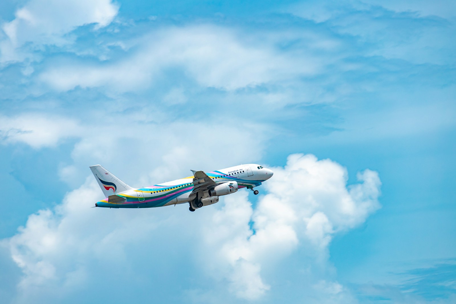 an airplane is flying through the blue sky