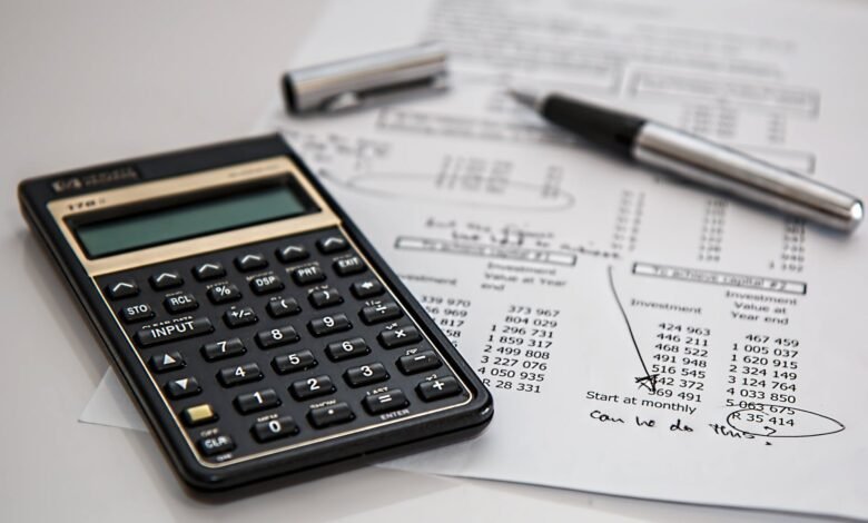 Close-up of financial documents with calculator and pen, ideal for business management themes.