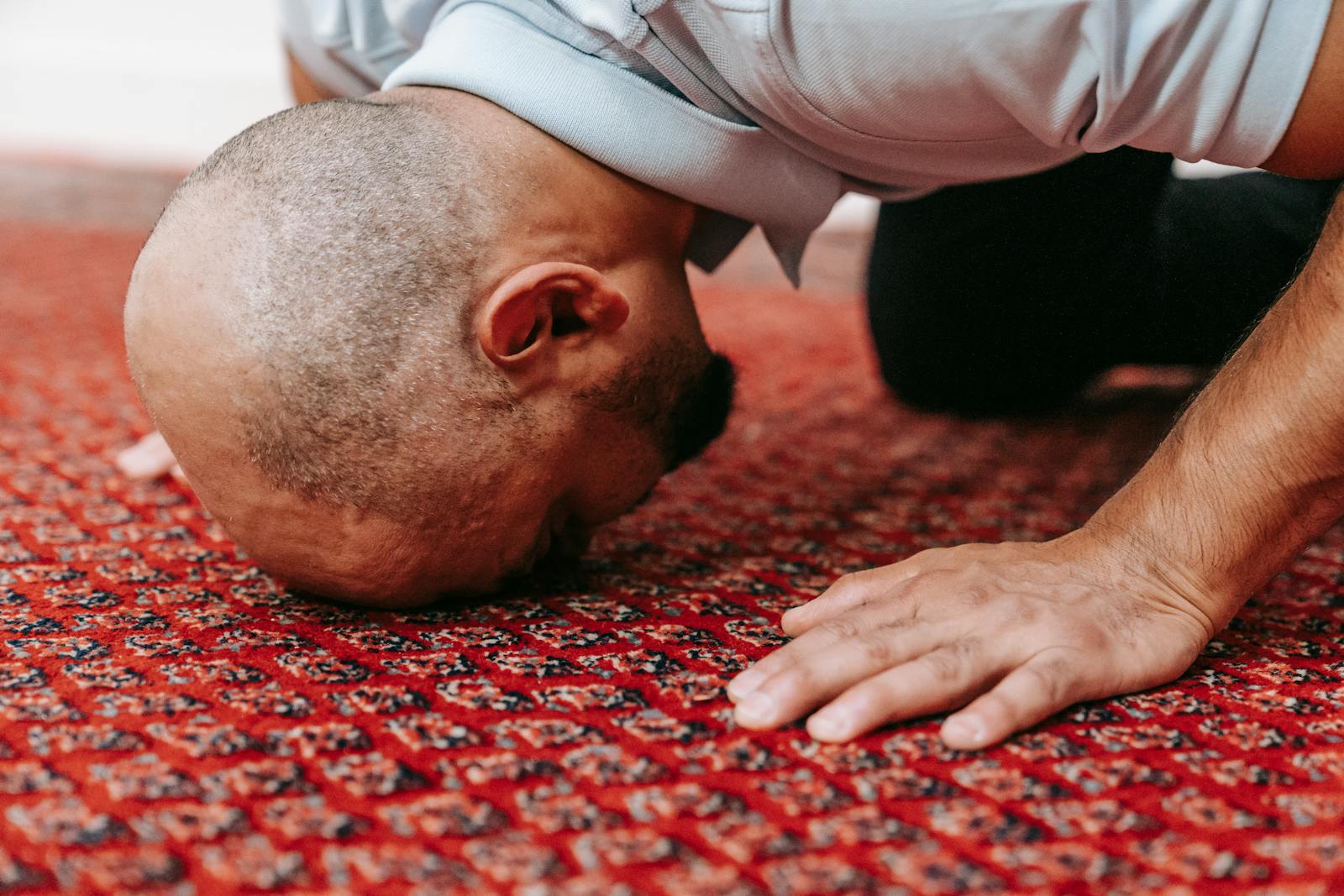 A Man Praying on the Floor