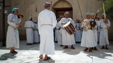 a group of people wearing white robes and holding instruments