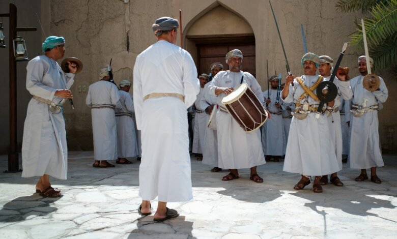 a group of people wearing white robes and holding instruments