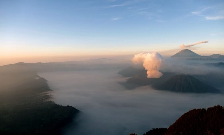 a view of a mountain with a cloud in the sky