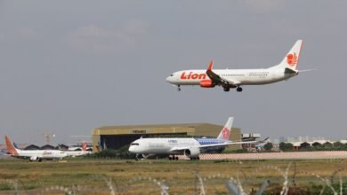 a large jetliner flying through a cloudy sky