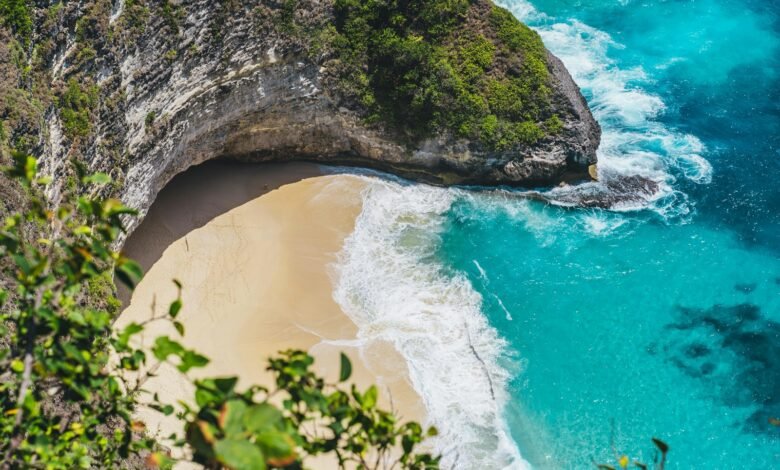 an aerial view of a beach and a cliff