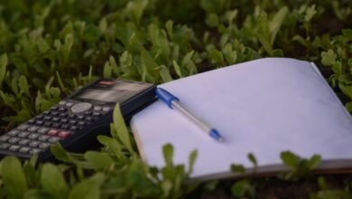 blue ballpoint pen on paper beside calculator