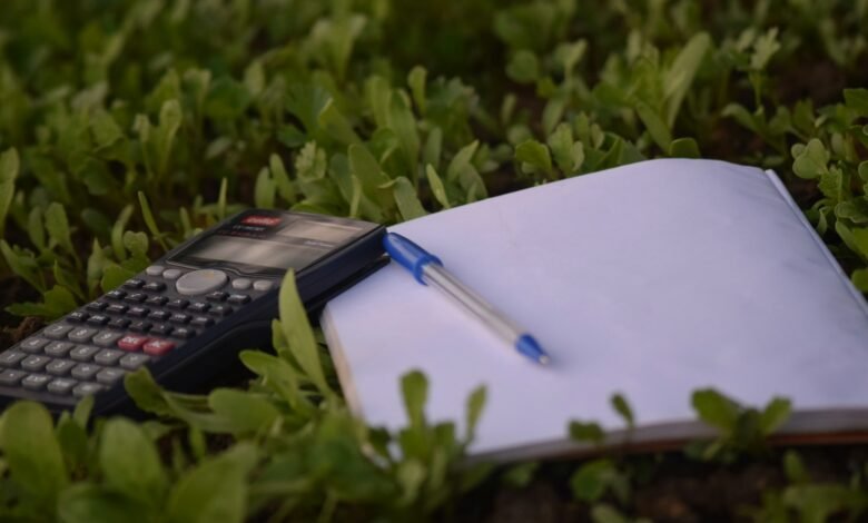 blue ballpoint pen on paper beside calculator