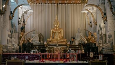 a golden buddha statue sitting in a room