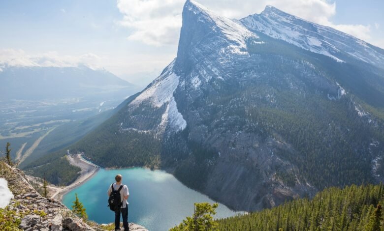 aerial photography of man standing on hill