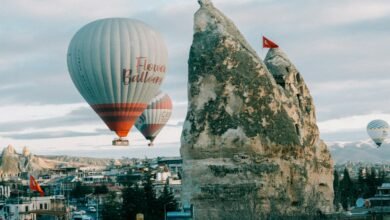 a couple of hot air balloons flying over a city