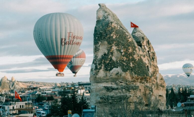 a couple of hot air balloons flying over a city