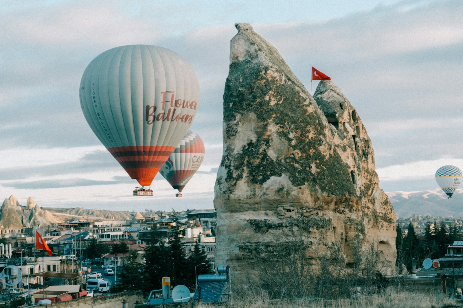 a couple of hot air balloons flying over a city