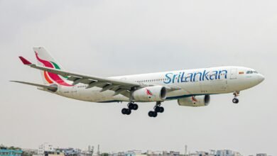 A large jetliner flying through a cloudy sky