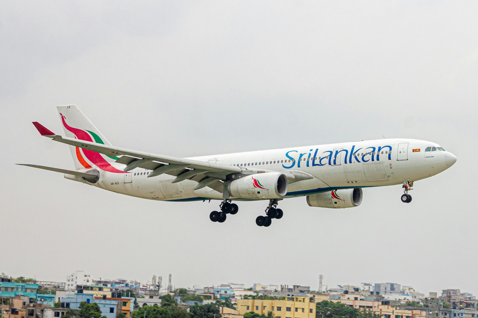 A large jetliner flying through a cloudy sky