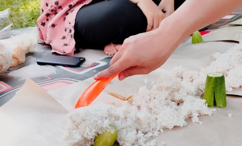 A woman is cutting carrots on a table