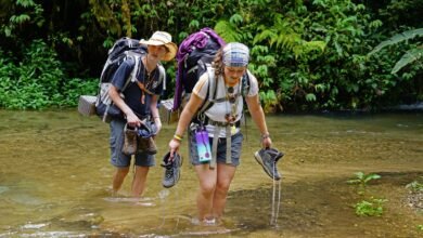 a couple of people that are walking in some water