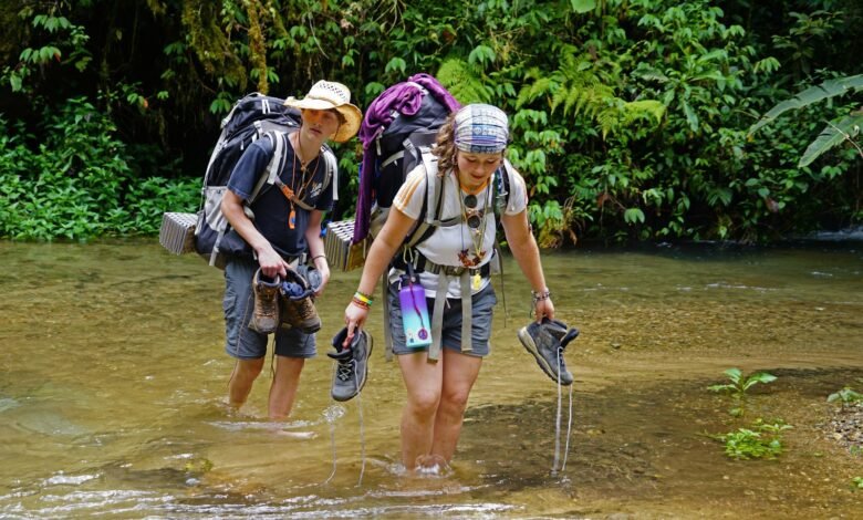 a couple of people that are walking in some water