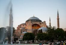 a large building with a dome and towers with Hagia Sophia in the background