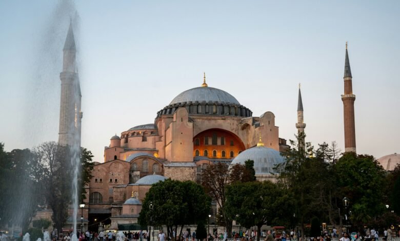 a large building with a dome and towers with Hagia Sophia in the background