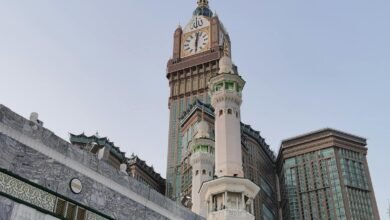 View of the iconic Abraj Al Bait and Mecca Clock Tower with surrounding architecture.