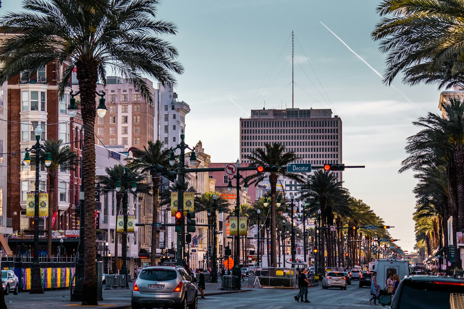 a city street with palm trees and traffic lights