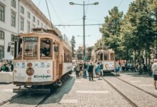 people walking on street near white and brown tram during daytime