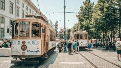 people walking on street near white and brown tram during daytime